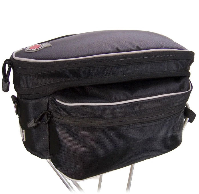 Studio image of Banjo Brothers Expanding Rack Top Bag Black bike rack bag showing top of bag expanded. Bag is black with silver reflective trim on top and sides