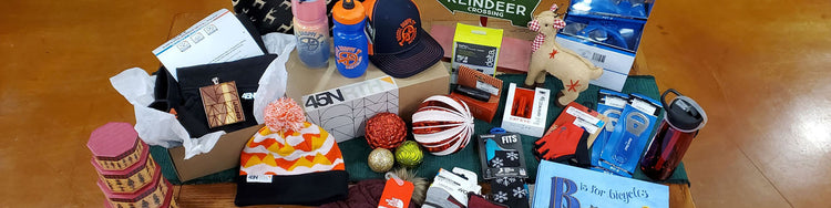 An assortment of bike accessories and gift ideas sit on a table decorated for the Christmas holiday.