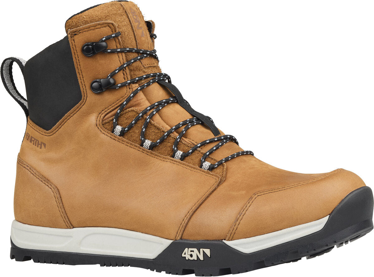Studio front quarter view of brown leather boot with a black and white sole, black and white laces and a black soft fabric area around upper ankle area. 