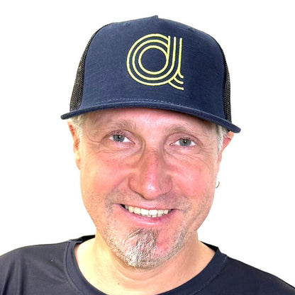 Front view of a man wearing an Azub Baseball Hat Dark Blue with lime  green "A" logo .