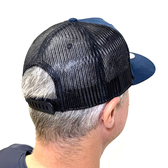 Back view of man wearing a baseball cap with a black mesh top and snap adjustment and dark blue front and bill. 