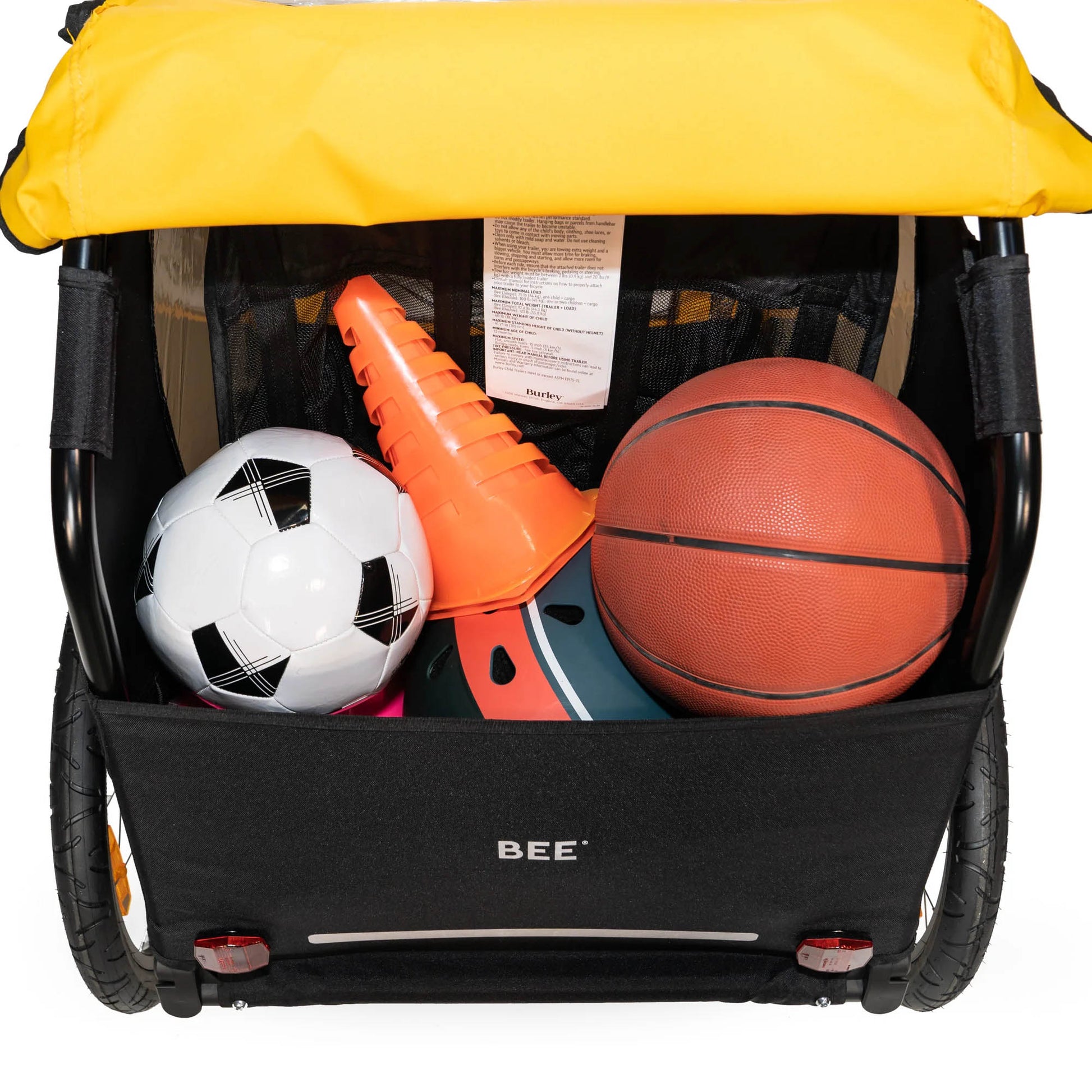 Rear view of the Burley Bee Single Child Trailer in Yellow, shown with sporting goods in the rear cargo area, with a white background.