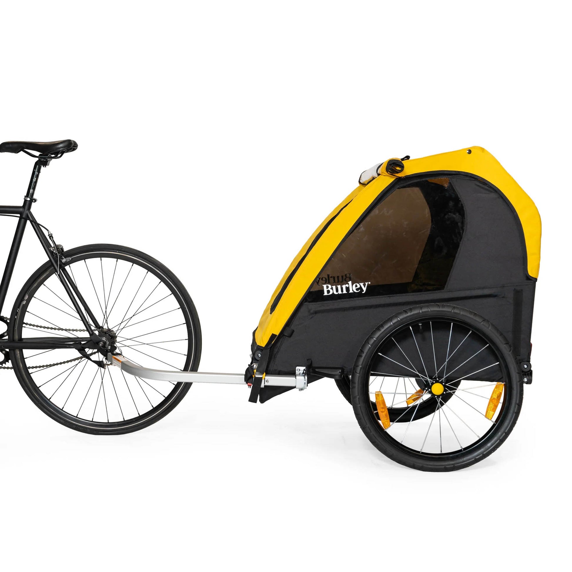 Side view of the Burley Bee Single Child Trailer in Yellow, shown attached to a bicycle, with a white background.