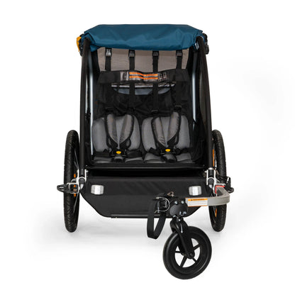 Front view of the Burley Encore X Child Trailer in Blue, shown with protective cover flipped up to reveal interior seats and belts, shown on a white background.