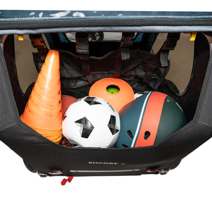 Rear view of the Burley Encore X Child Trailer in Blue, showing the cargo area  filled with sporting equipment, shown on a white background.