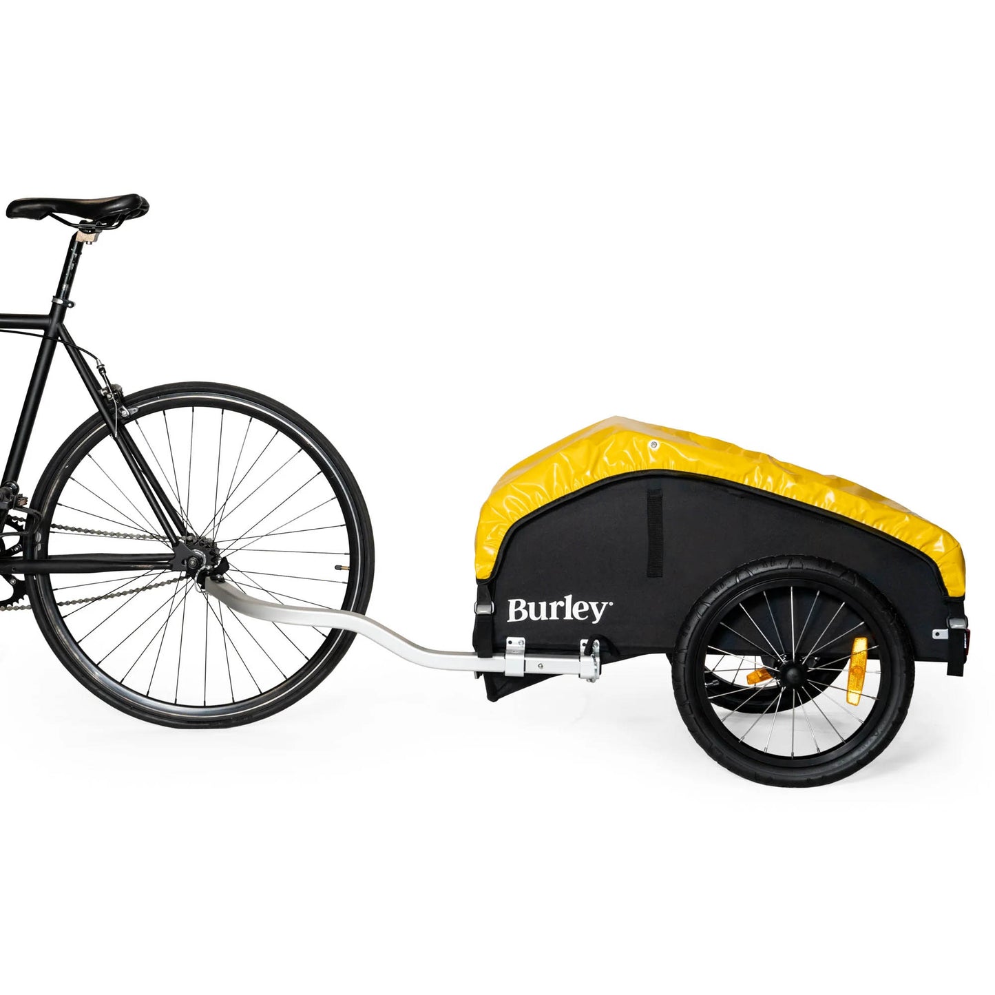 Side view of the Burley Nomad Cargo Trailer, shown attached to a bicycle, on a white background.