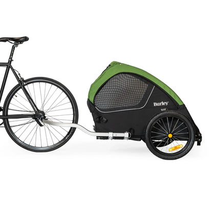 Side view of the Burley Tail Wagon Pet Trailer, shown attached to a bicycle, on a white background.