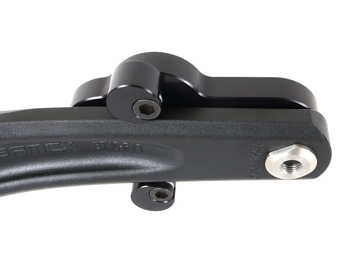 The back view of a pair of CJ Ackley Machine Company Wide Crank Arm Shorteners in black mounted on a crank arm.
