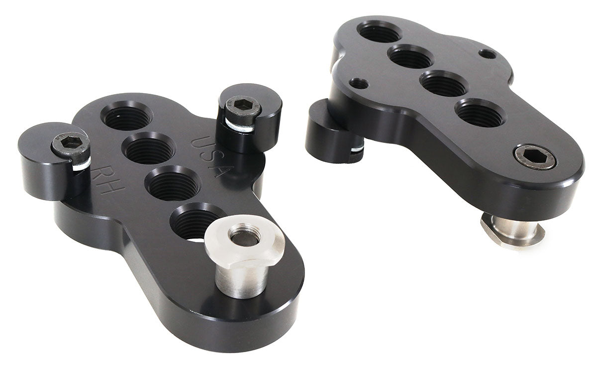 A top and bottom view of a pair of CJ Ackley Machine Company Wide Crank Arm Shorteners in black.