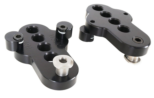 A top and bottom view of a pair of CJ Ackley Machine Company Wide Crank Arm Shorteners in black.