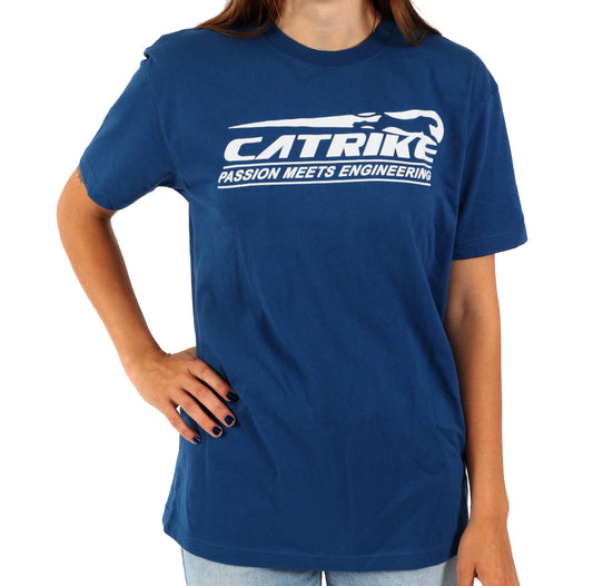 Studio front view of woman wearing royal blue shirt with white Catrike logo across the chest and lettering that says Passion meets engineering below the logo.