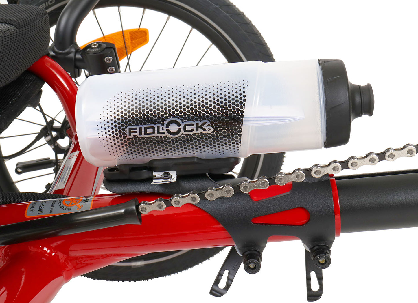 Fidlock TWIST 600 Bottle and Bike Base, studio side view, shown mounted on a red recumbent trike.