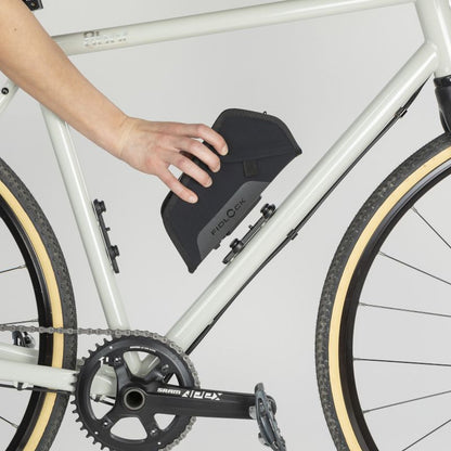 Road biker removing Fidlock TWIST Essential Medium Bag Black from their Fidlock TWIST bike base