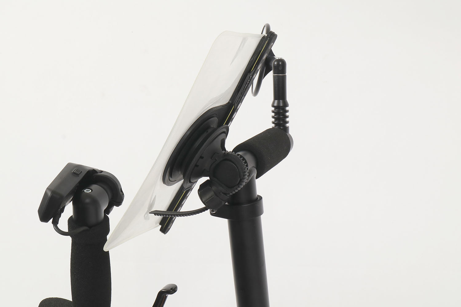Studio side profile view of a Fidlock VACUUM Handlebar Base Flex mount installed on a stand-up aid of a recumbent trike