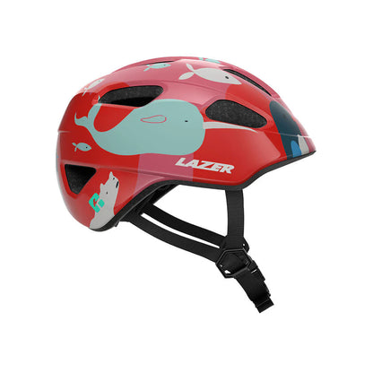 Profile studio view of a toddler sized bicycle helmet with red background  with white polar bears, mint narwhals, dark blue whales, and white fish scattered throuhgout.
