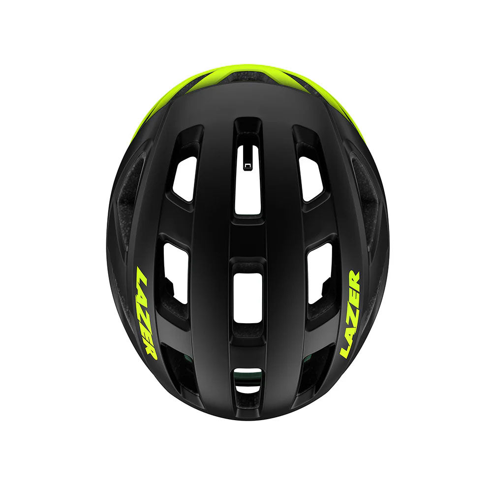 Studio top view of a black bicycle helmet that fades to neon yellow at the back, with neon yellow Lazer decal across both sides of the helmet.