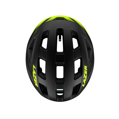 Studio top view of a black bicycle helmet that fades to neon yellow at the back, with neon yellow Lazer decal across both sides of the helmet.