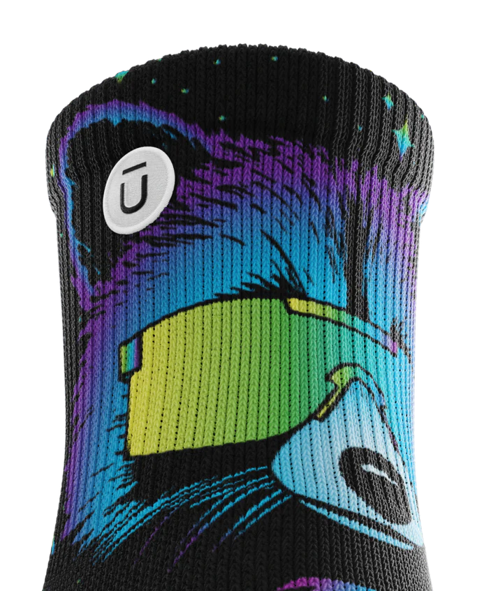 Top cuff of Pair of black sock with heads of racoons wearing sunglasses.   Racoon has blues, purples, teals, and yellows, background is black.  Circular white patch with Outway logo on top third of cuff