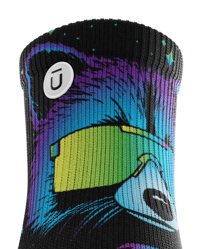 Top cuff of Pair of black sock with heads of racoons wearing sunglasses.   Racoon has blues, purples, teals, and yellows, background is black.  Circular white patch with Outway logo on top third of cuff