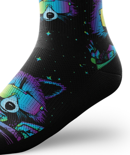 Ankle view of a black sock with heads of racoons wearing sunglasses and garbage cands.  Racoons and garbage cans are blues, purples, teals, and yellows, background is black.