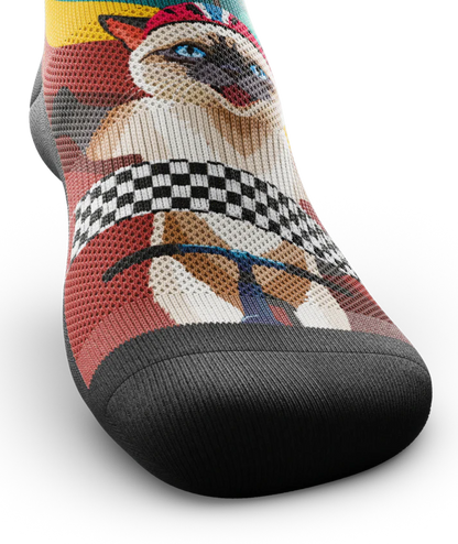 Front toe view  of a multicolored sock with cats wearing helmets riding bikes in a race