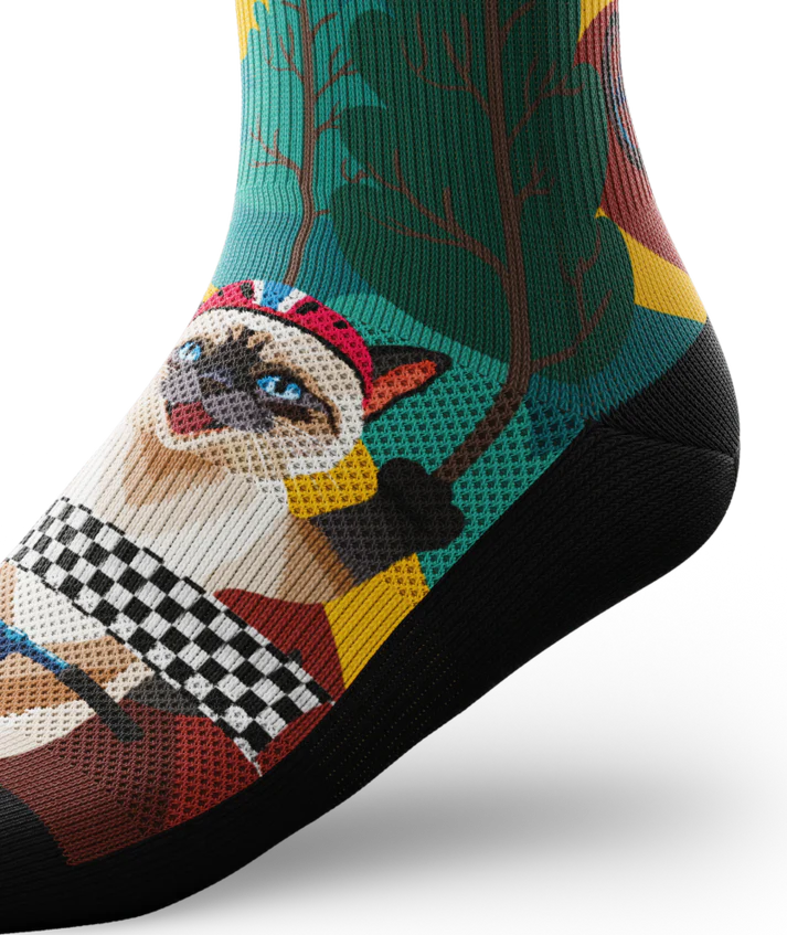 Ankle view of a multicolored sock with cats wearing helmets riding bikes in a race