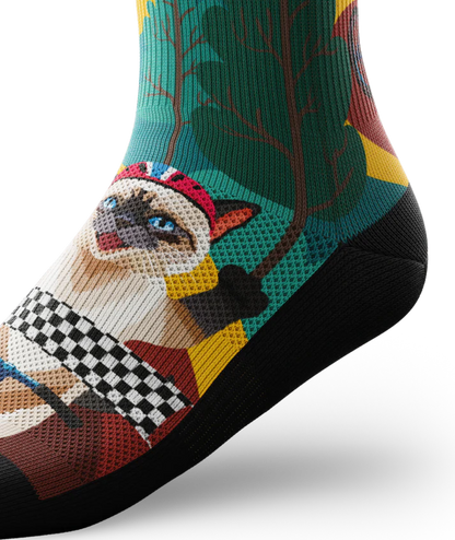 Ankle view of a multicolored sock with cats wearing helmets riding bikes in a race
