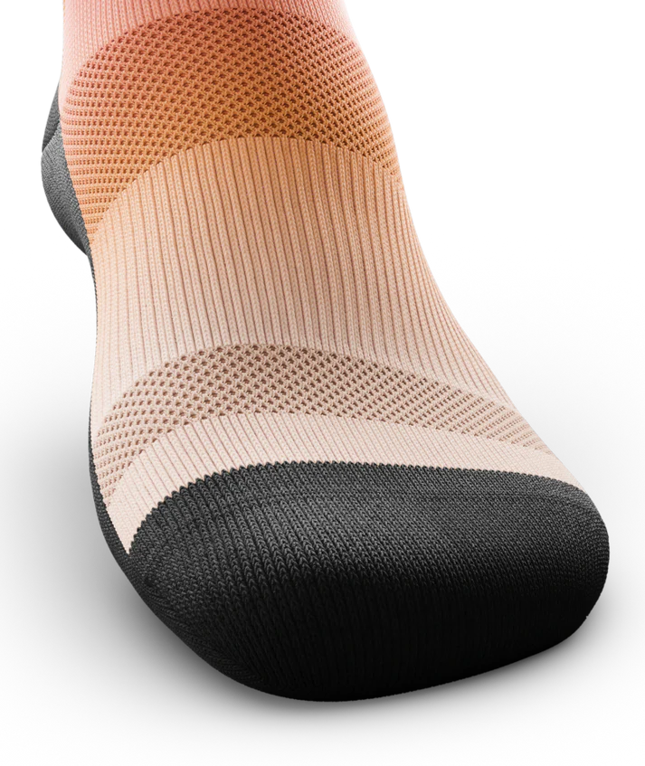 Top toe area of a Multicolored sock light orange near toes. Sole and toe of socks is black