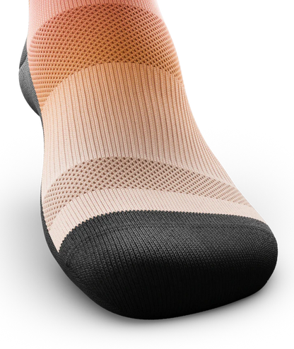 Top toe area of a Multicolored sock light orange near toes. Sole and toe of socks is black