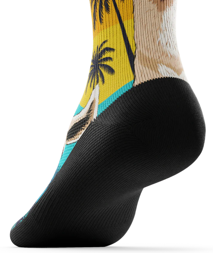 Bottom black sole of sock with with ocean sunset, black palm trees, and heads of llamas on main part of sock.