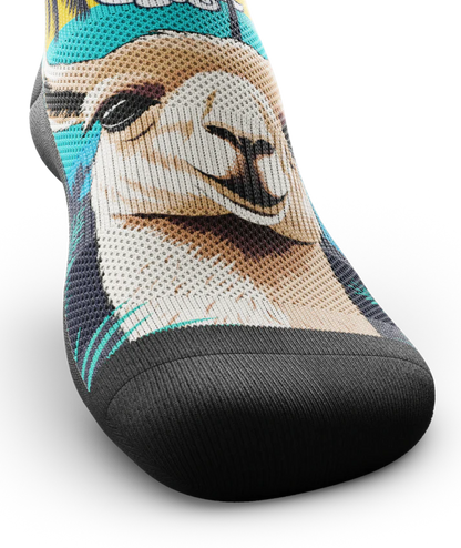 Front toe view of sock with with ocean sunset, black palm trees, and heads of llamas on main part of sock.