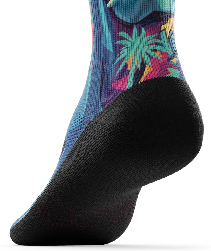 Bottom sole of multicolored  sock with T-rex dinosaurs and palm trees on main part of sock