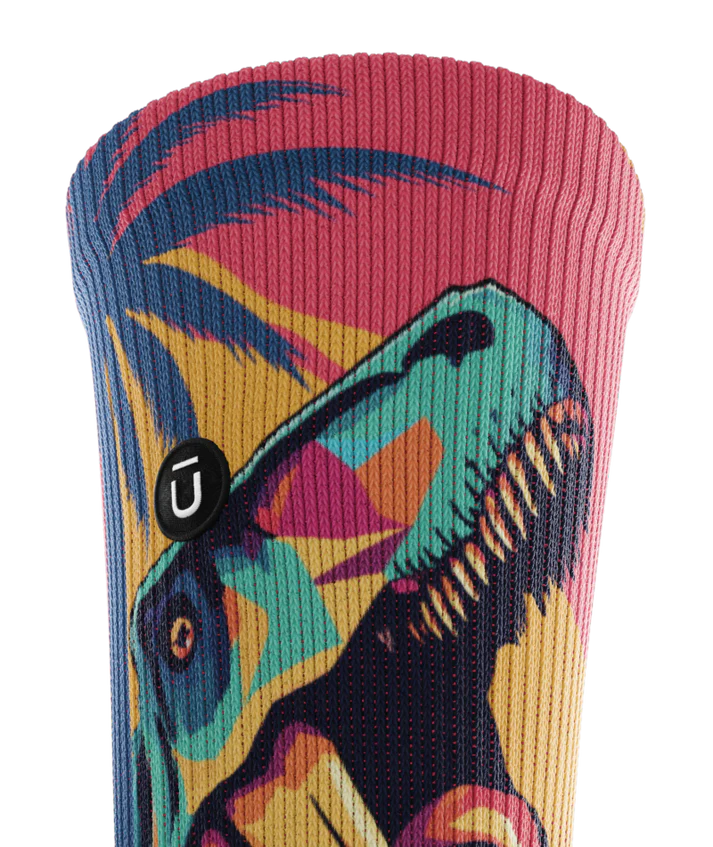 Top cuff of multicolored sock with T-rex and palm trees.  Small black circular patch with Outway logo on top third of sock.