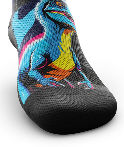 Top toe area of sock with blue yellow and orange velociraptor across top of sock .  Toe and sole are black. 