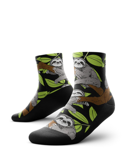 Pair of socks with grey sloths in trees with black background and soles