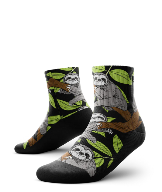 Pair of socks with grey sloths in trees with black background and soles