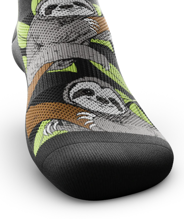 Top toe view of sock with sloths in trees on main part of sock
