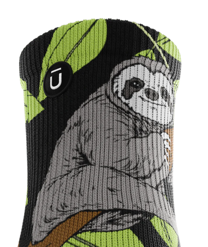 Top of cuff view of sock with sloths in trees on main part of sock. Small black circular patch with Outway logo on top third of cuff. 
