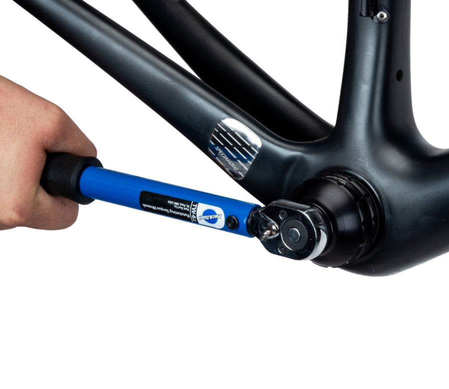 Man wrenching on bottom bracket with Park Tool BBT-35-12 Bottom Bracket Tool.