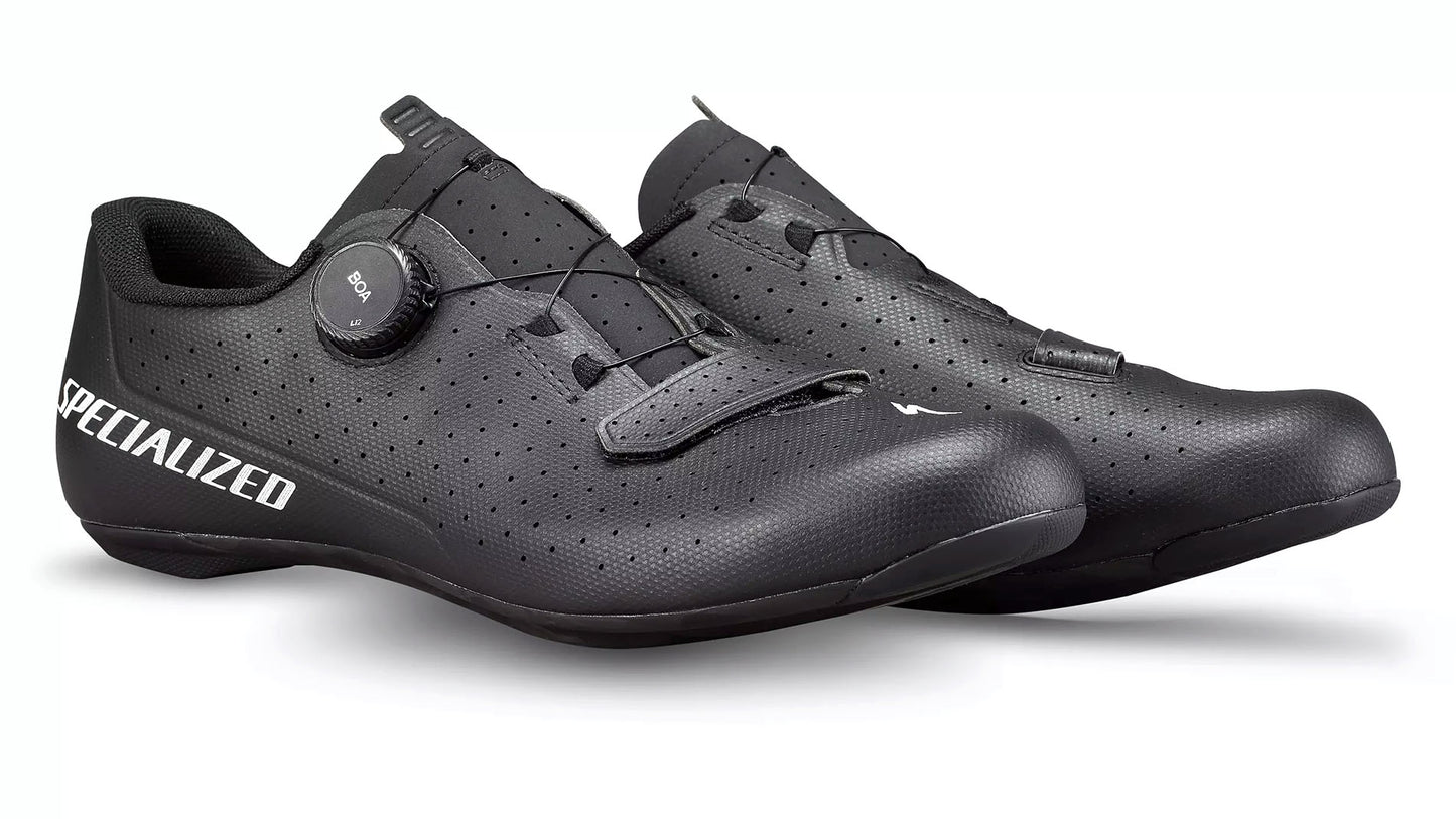 Studio front quarter view of a pair of black shoes with a white S on the top of the toe and white Specialized lettering across outside of heel.