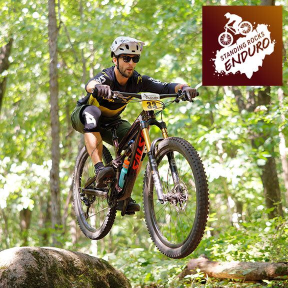 A mountain biker flies through the air over a rock at the Standing Rocks Enduro.
