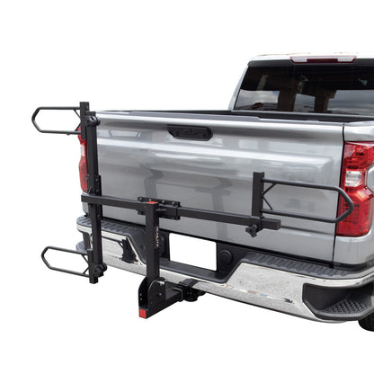 Folded up view of the Sunlite HRT-100 Trike Auto Rack for 2-inch Receivers mounted on the hitch on a pickup truck against a white background.