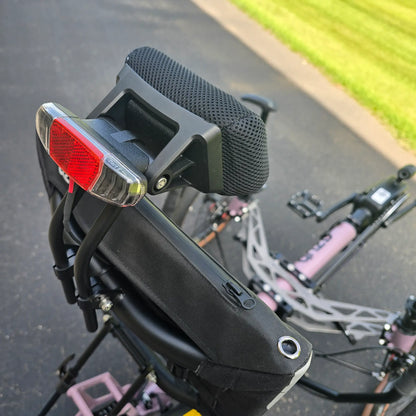 Closeup view of the neckrest and taillight on the Azub Demo Ti-Fly 20 Enviolo Shimano EP6 Pastel Violet Recumbent Trike in an outdoor setting.