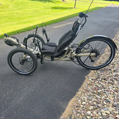 Non-drive side view of the Azub Demo Ti-Fly 26 Bosch Performance CX Dark Sand Recumbent Trike in an outdoor setting.