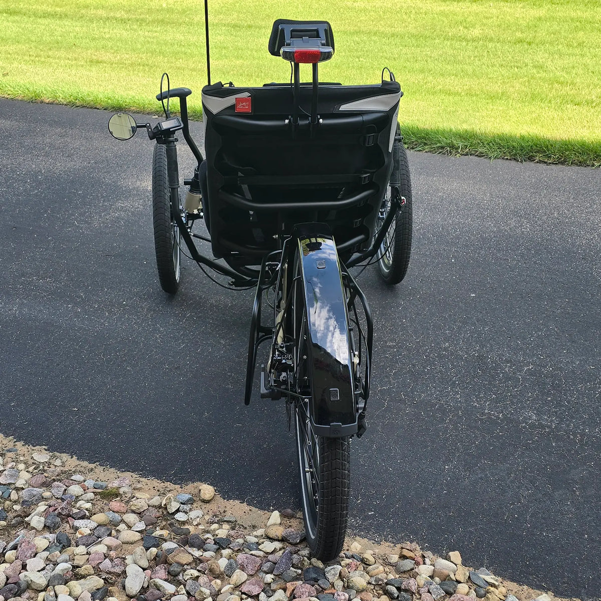Rear view of the Azub Demo Ti-Fly 26 Bosch Performance CX Dark Sand Recumbent Trike in an outdoor setting.
