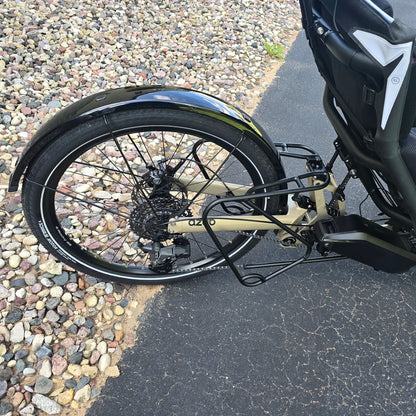 Closeup view of the mid rack, rear wheel, cassette, battery and rear derailleur on the Azub Demo Ti-Fly 26 Bosch Performance CX Dark Sand Recumbent Trike in an outdoor setting.