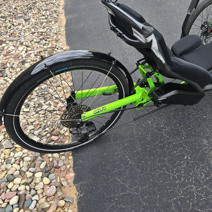 Closeup view of the rear fender, rear wheel, cassette, derailleur and battery on the Azub Demo Ti-Fly 26 Bosch Performance CX Lime Green Recumbent Trike in an outdoor setting.