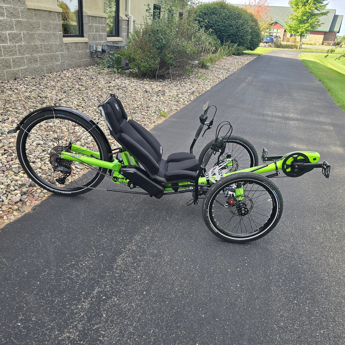 Side view of the Azub Demo Ti-Fly 26 Bosch Performance CX Lime Green Recumbent Trike in an outdoor setting.
