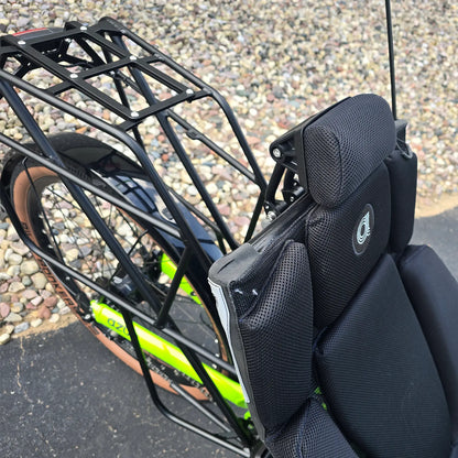 Closeup view of theneckrest and king rack on the Azub Demo Ti-Fly X Rohloff E14 Bosch Performance CX Dual Battery Lime Green Recumbent Trike in an outdoor setting.