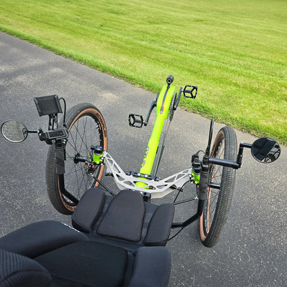 Closeup view of the handlebars with controls, dual mirros, phone holder and front suspension on the Azub Demo Ti-Fly X Rohloff E14 Bosch Performance CX Dual Battery Lime Green Recumbent Trike in an outdoor setting.